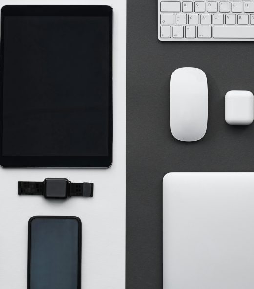Stylish flatlay of modern tech gadgets including tablet, smartphone, smartwatch, and accessories.