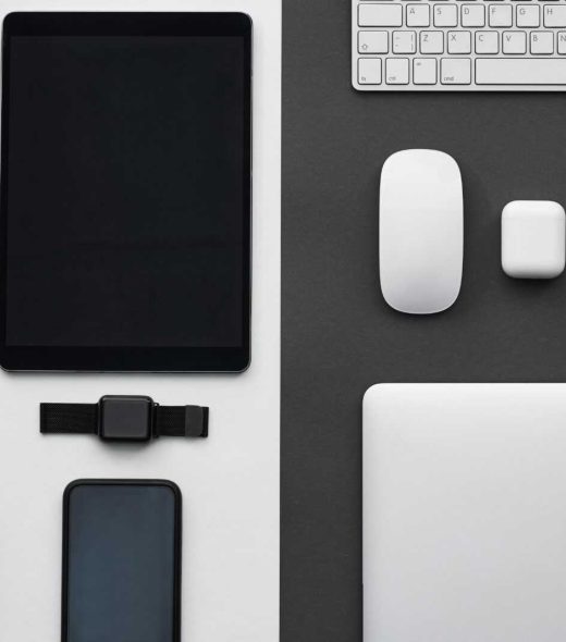 Stylish flatlay of modern tech gadgets including tablet, smartphone, smartwatch, and accessories.