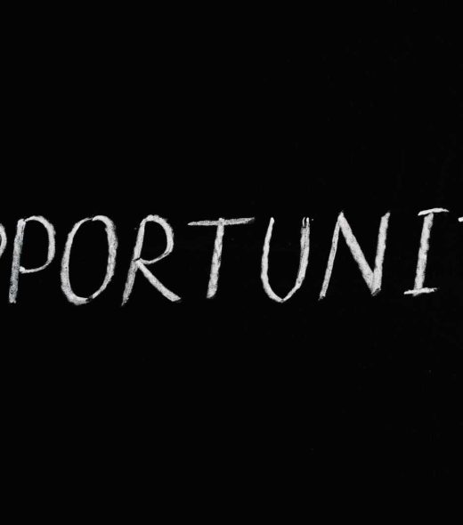 Word 'Opportunity' written in chalk on a black chalkboard, symbolizing new possibilities.
